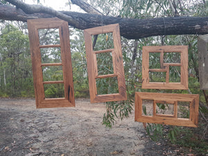 Rustic multi opening photo frames that hang on the wall.